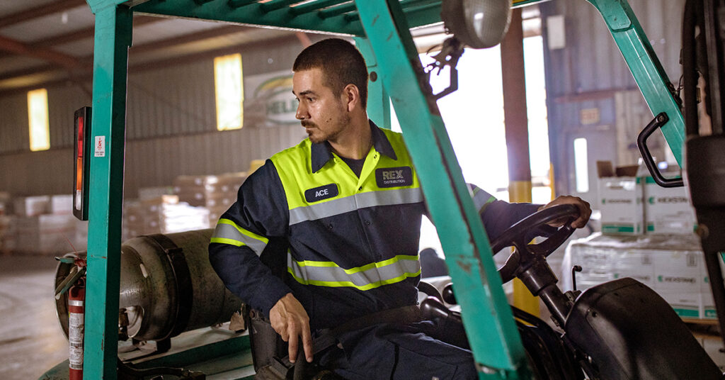 Worker wearing ANSI Class 3 High Visibility Shirts at a job site