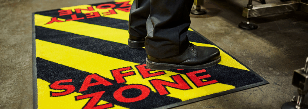 Close-up of staff standing on a UniFirst safety floor mat