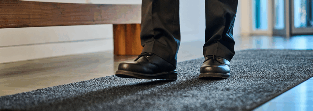 Close-up of staff standing on a UniFirst commercial floor mat