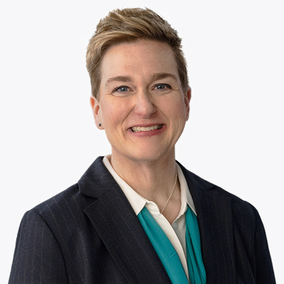 A portrait of Kelly Rooney, Executive Vice President and COO at UniFirst Corporation