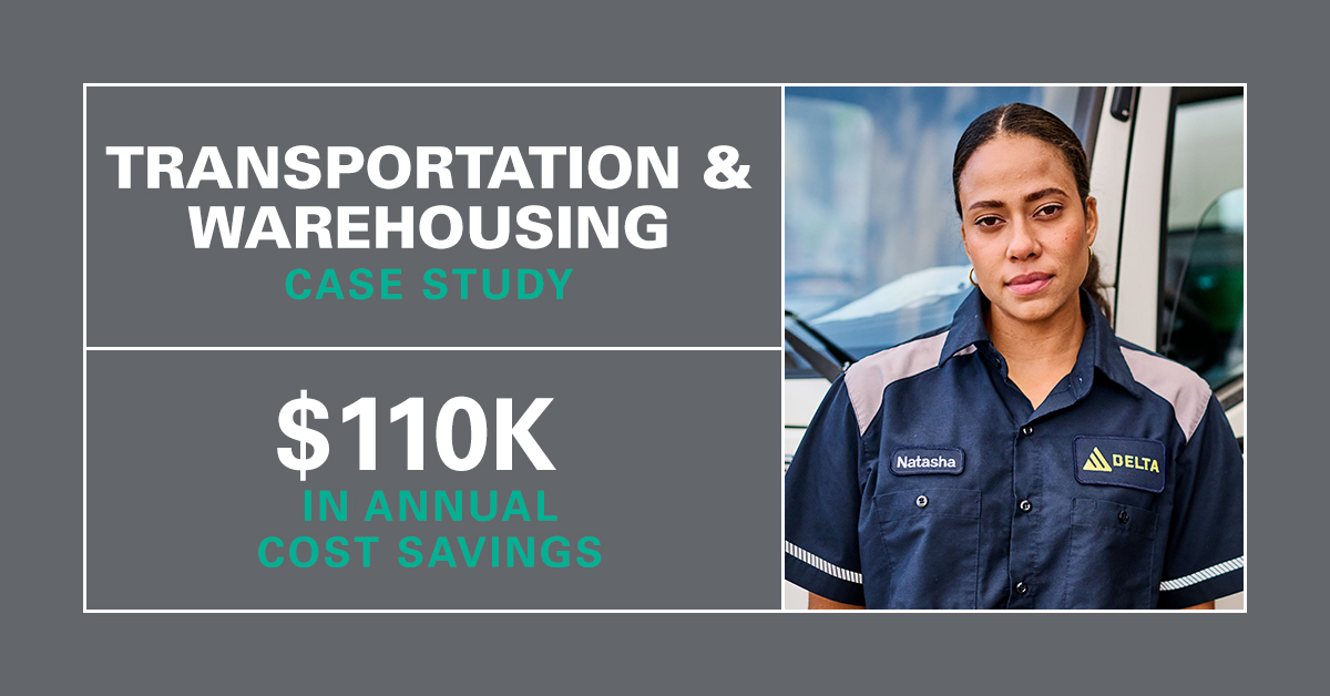 Woman working in the transportation and warehousing industry standing in front of a truck wearing UniFirst workwear