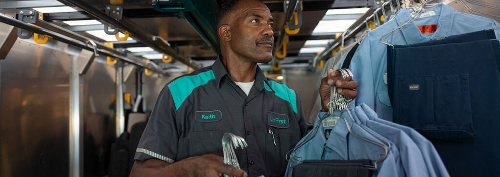 A UniFirst RSR loading his truck and ensuring he deliver the best uniform rental services
