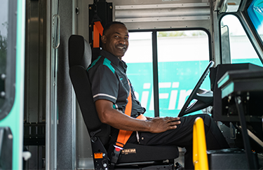 A UniFirst RSR sitting in his delivery truck ready to take on his route and deliver uniform rental service