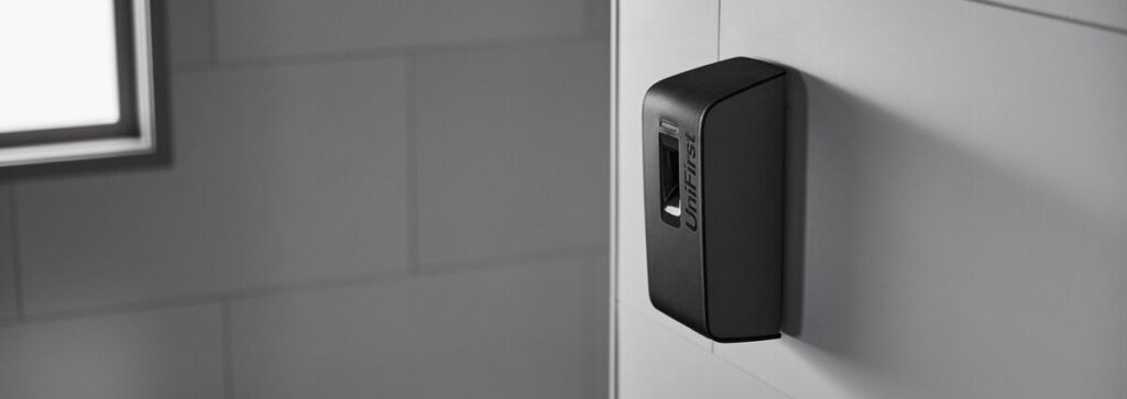 A close-up of an Essential Series Automatic Air Freshener dispenser