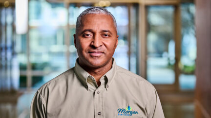 A uniform rental program customer standing proudly while wearing his workwear